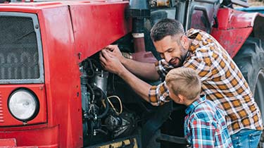 Father and Son Repairing Tractor