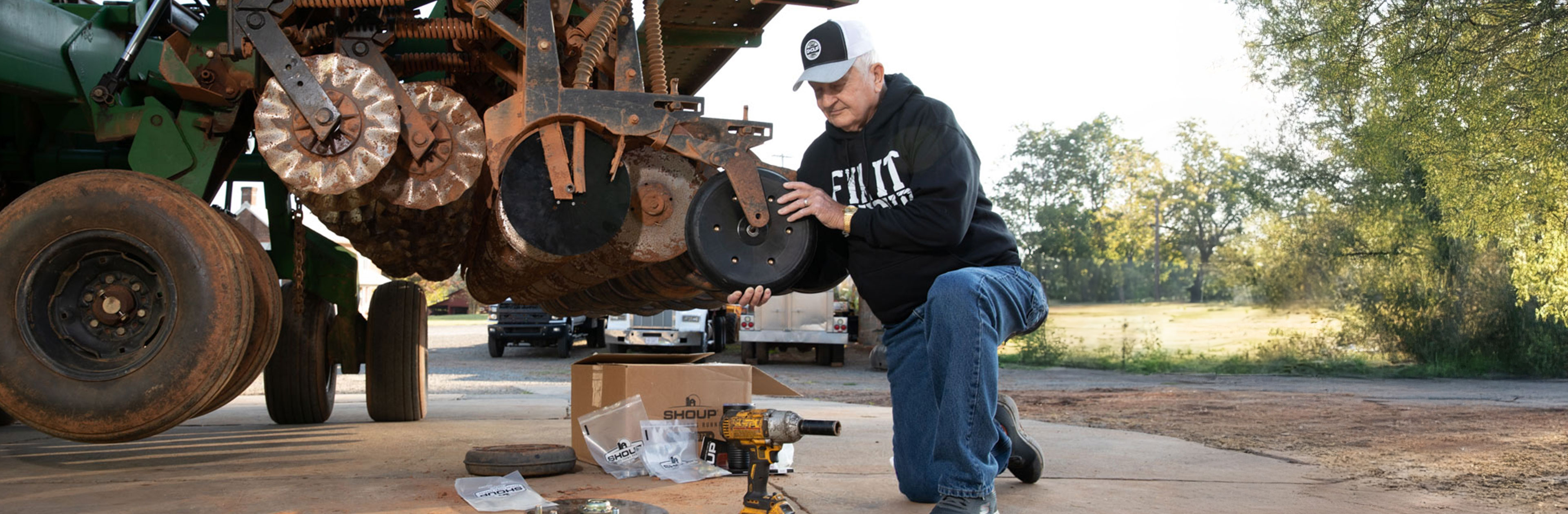 Man working on machine in Shoup sweater